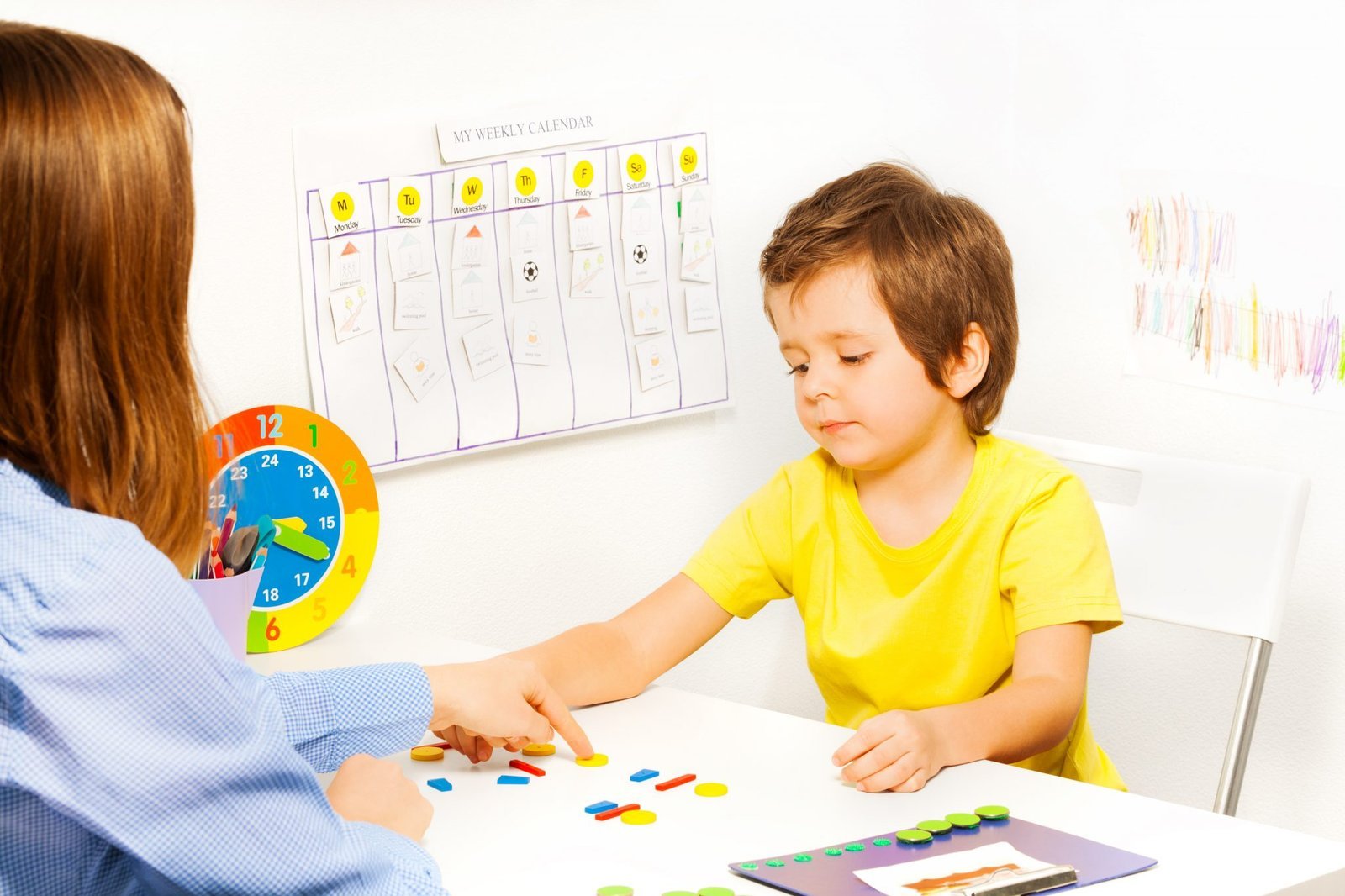 a boy playing with a finger on a table