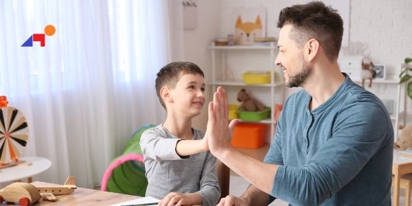 male therapist working with little boy for pediatric occupational therapy session