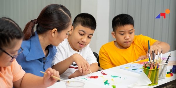 Children painting with an instructor for pediatric occupational therapy